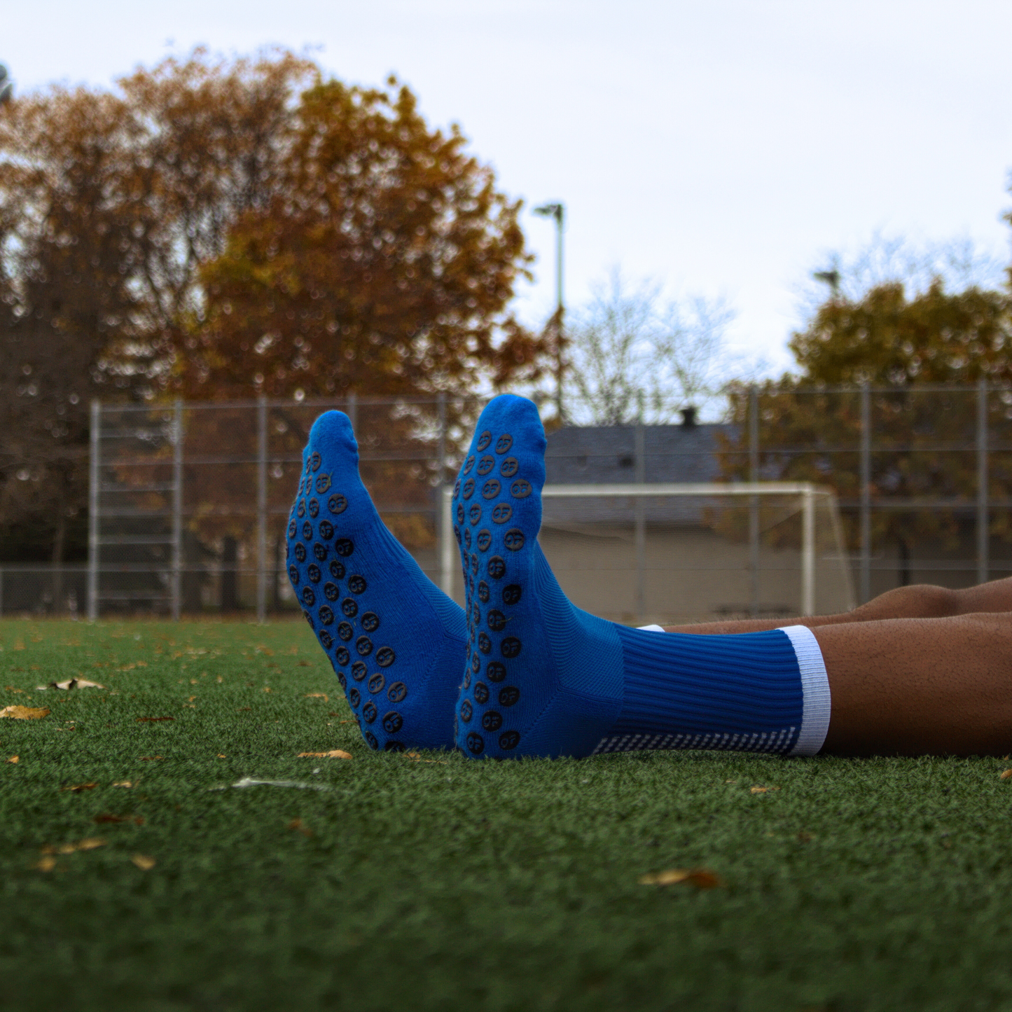 Blue grip socks, view from the bottom, soccer field